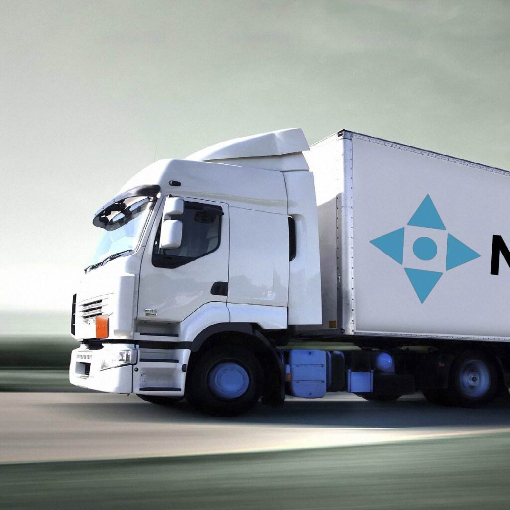 Freight truck driving on highway at sunset